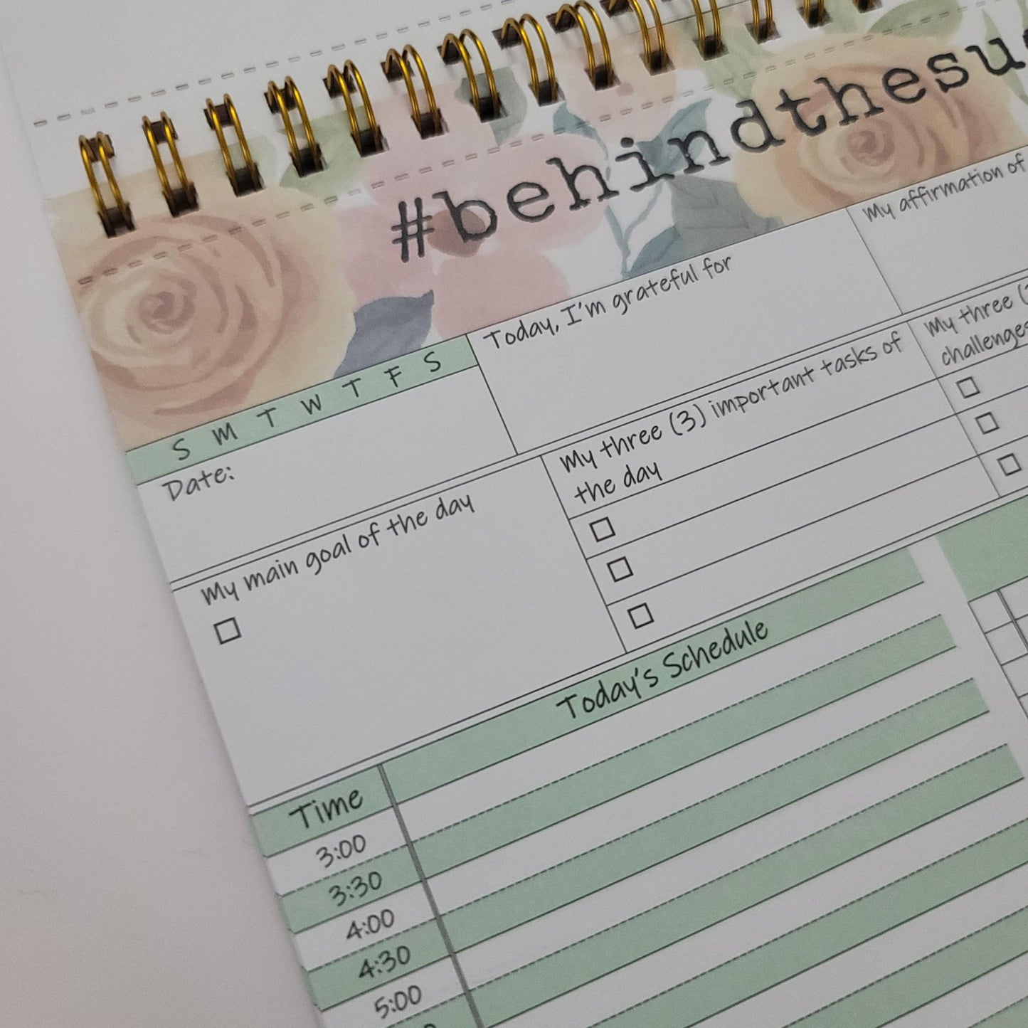 Undated daily productivity planner page with floral design, gratitude and schedule sections