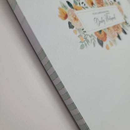 Undated daily notepad with floral cover, stitched binding, white background