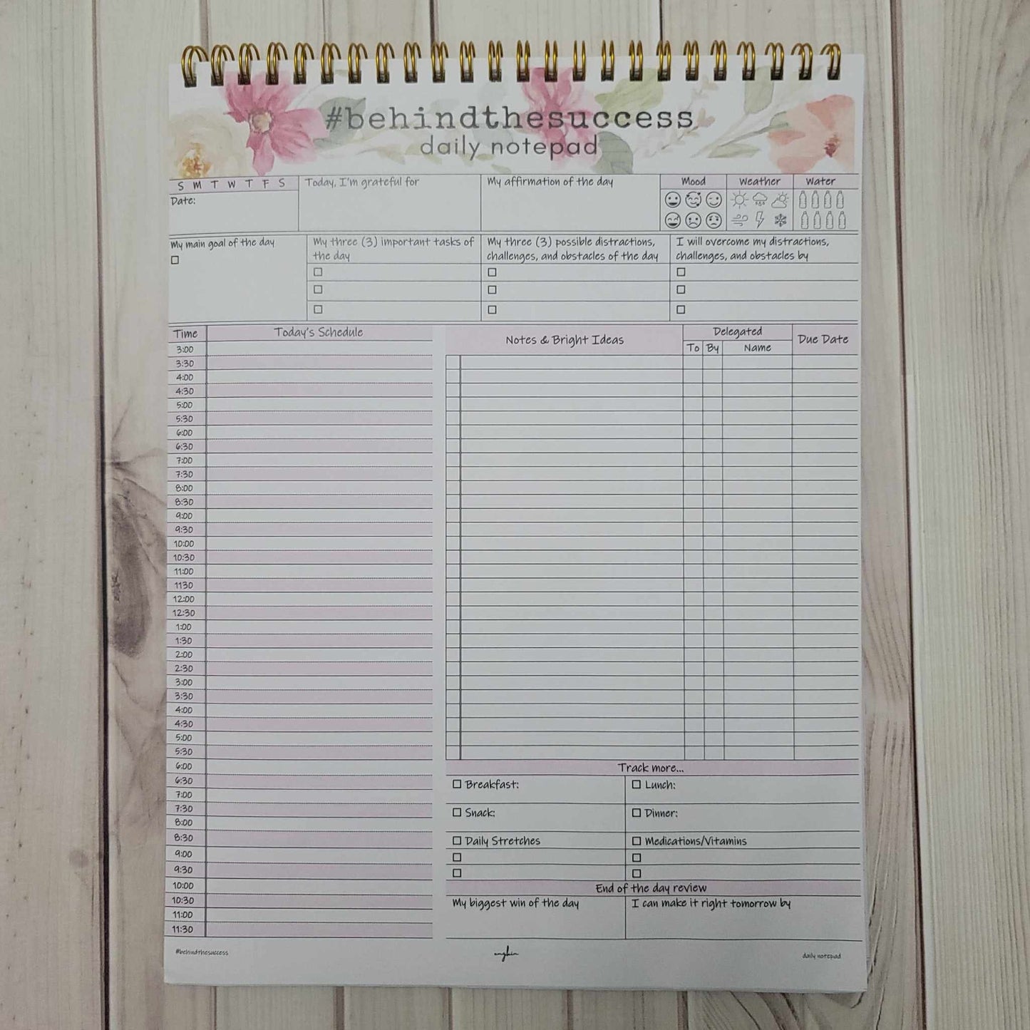 Undated daily productivity planner notepad with schedule, goals, gratitude, meal and habit tracker.