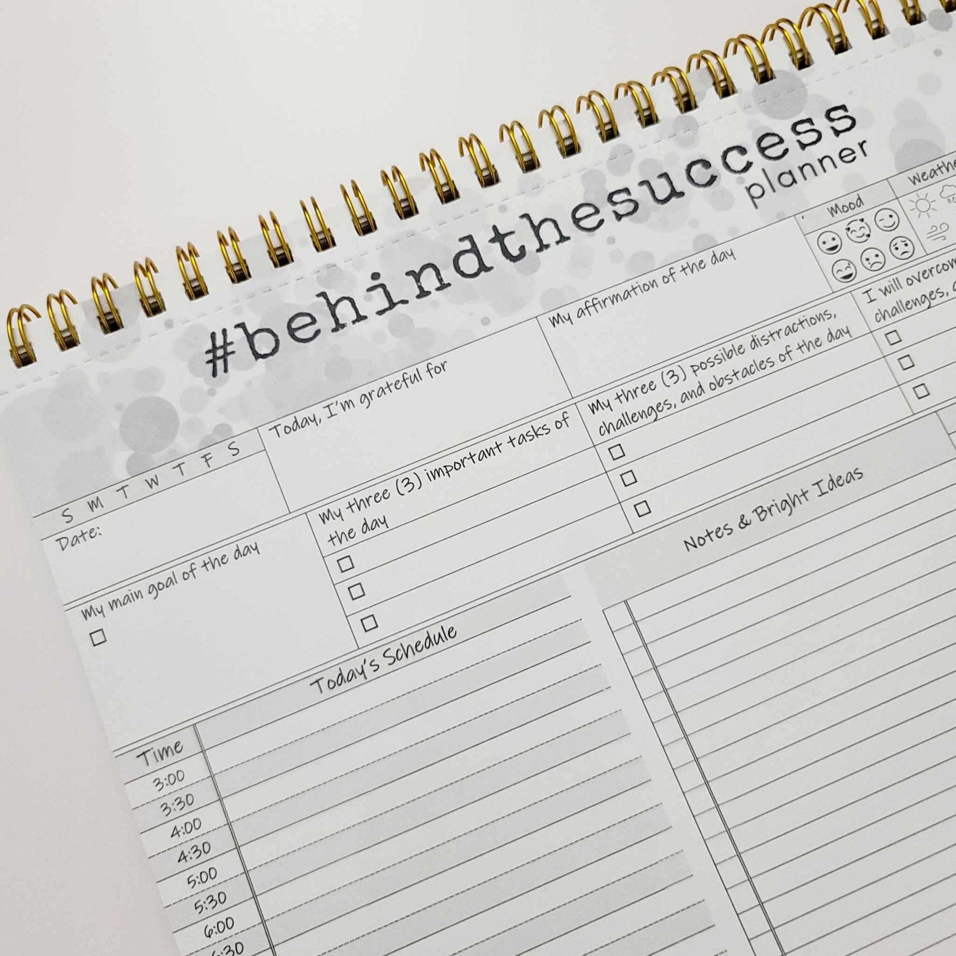 Undated spiral-bound productivity planner with gratitude, goal, task, and schedule sections.