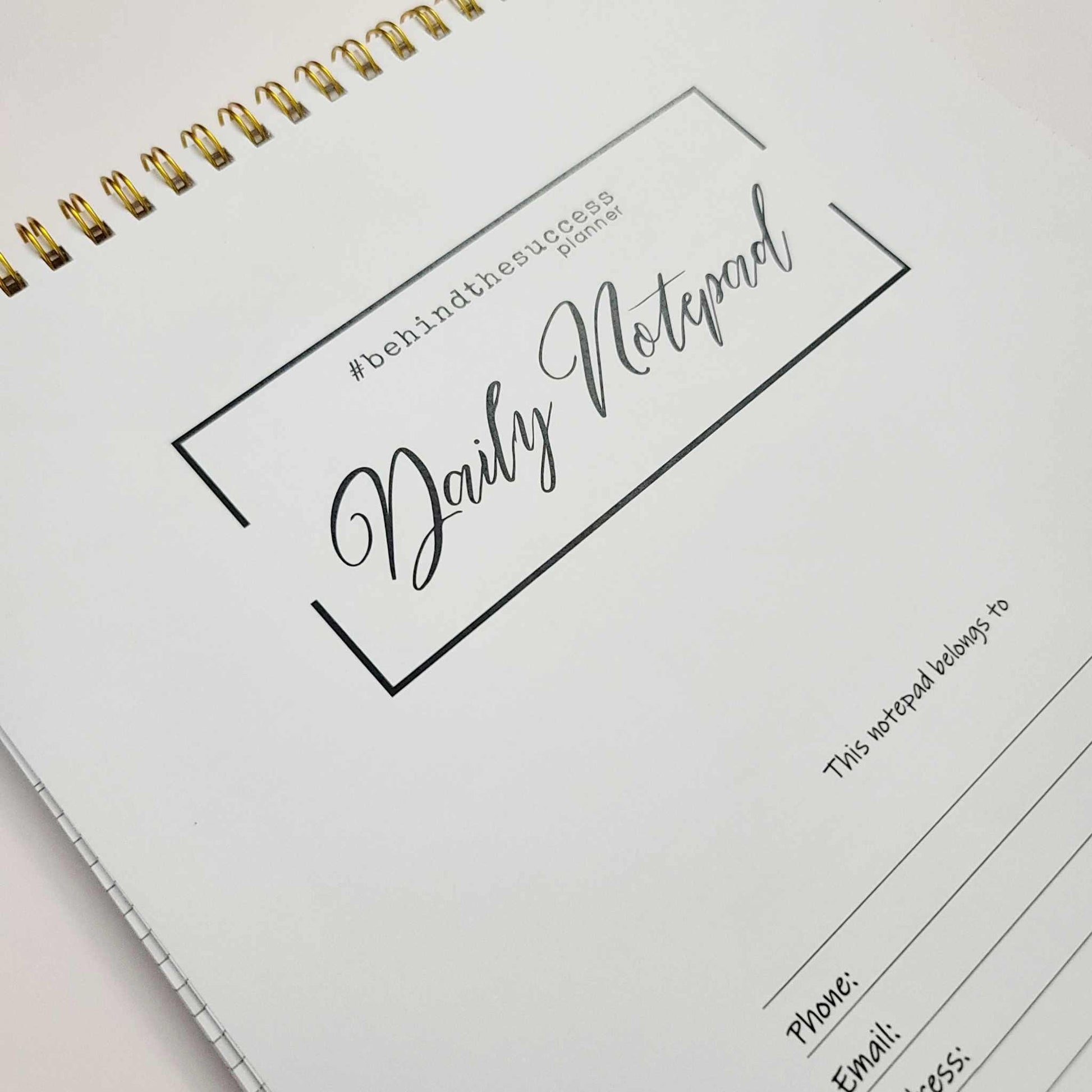Daily notepad planner with gold spiral binding for productivity and goal tracking