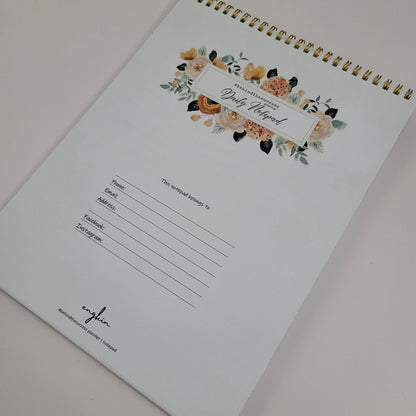 Floral undated productivity planner notepad with gold spiral binding, contact info section.